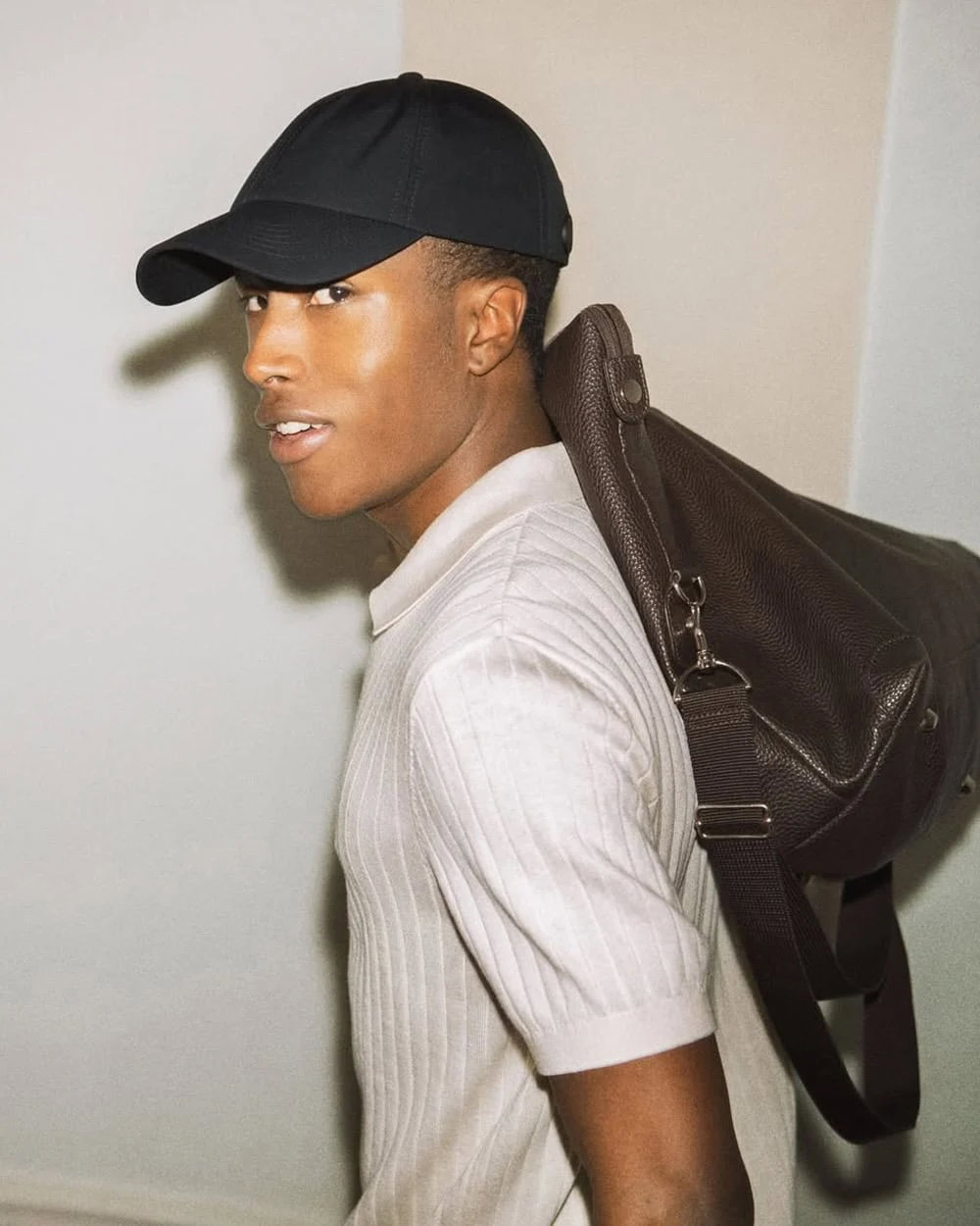a man wearing a hat and carrying a backpack