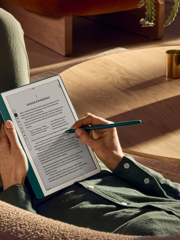 Someone writing on a Kindle Scribe.