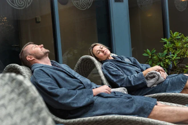 couple relaxing on loungers at the well spa