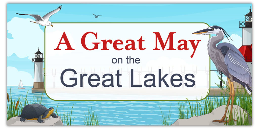 Promotional banner titled 'A Great May on the Great Lakes' featuring a scenic lake view with wildlife. It includes a great blue heron standing on a rock, a turtle sunning itself, and a seagull flying overhead. The background shows a lighthouse, sailboats, and distant shores, capturing the essence of the Great Lakes region in spring.