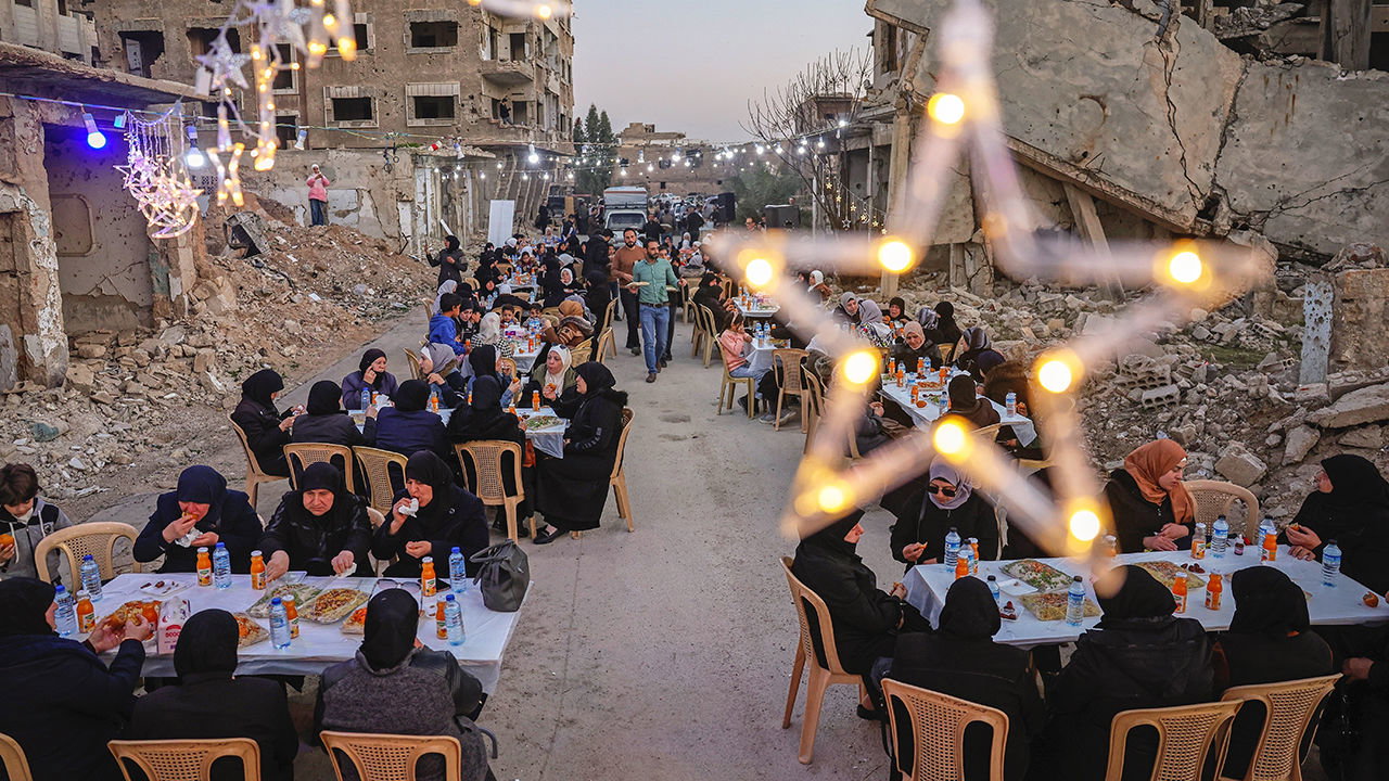 Widows and mothers of war victims gather for Iftar, the fast-breaking meal amid the rubble of homes of the Jobar neighborhood in Damascus