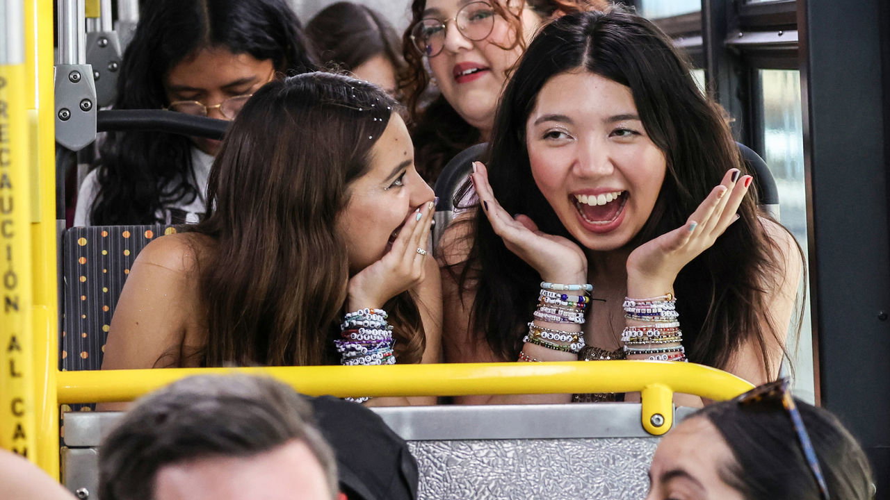 Teenagers share their excitement as they ride a free shuttle bus to a Taylor Swift concert.