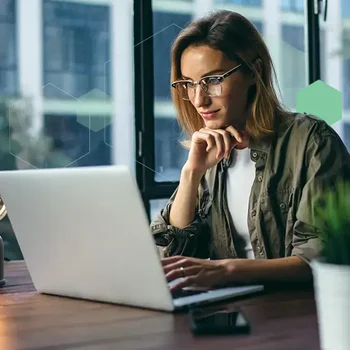 Surgent-CPE-unlimited-plus-cpe-subscription-business-woman-watching-self-study-on-demand-webcast-at-office-in-evening