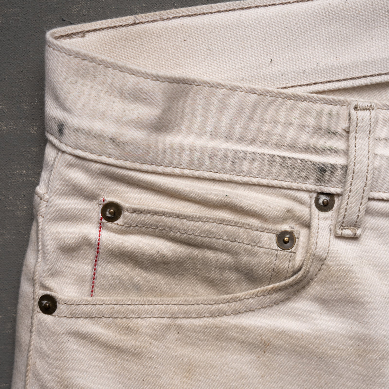 close-up of heritage workwear jeans in natural off-white selvage denim