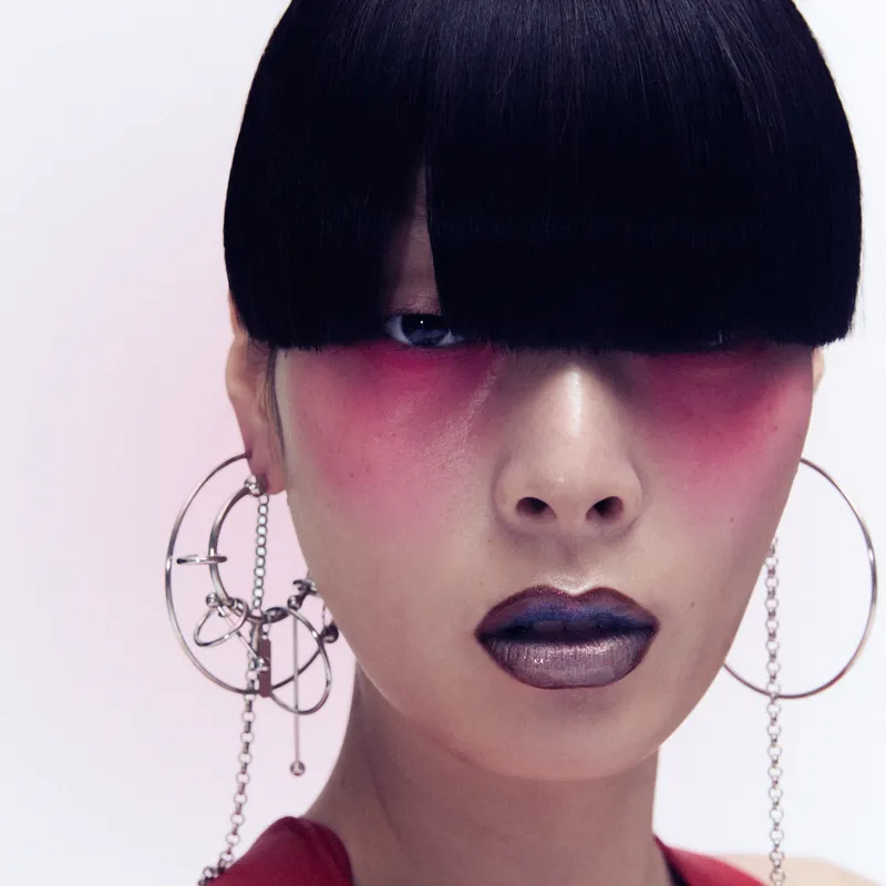Model wearing pink eye shadow against pink background