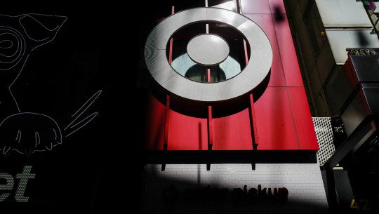 A Target bullseye outside a store, partly in shadow