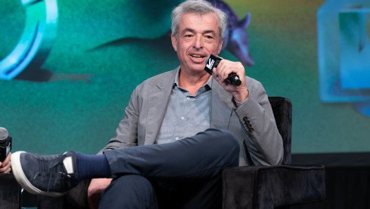 Eddy Cue speaks into a handheld microphone