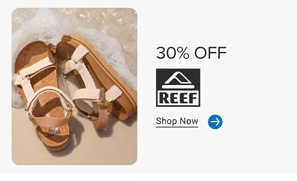 A pair of Reef sandals on a beach. 30% off Reef. Shop now.
