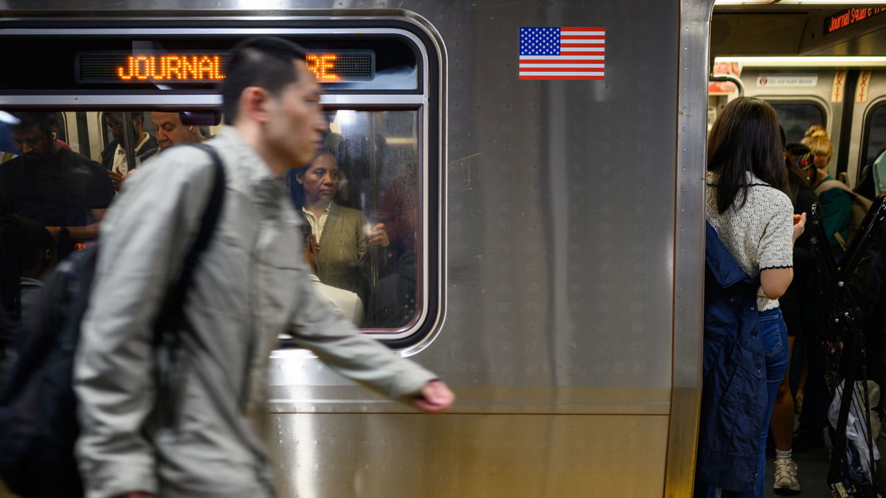 Commuters wait for a delayed Path Transit line to depart during rush hour at 33rd Street in New York City, USA.