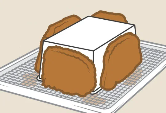 Illustration of leaning cooked tonkatsu against a loaf pan