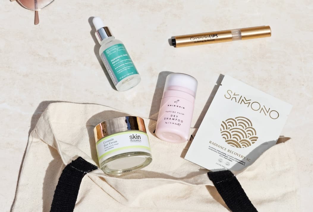 Jet Set Glow products displayed with a travel tote bag.