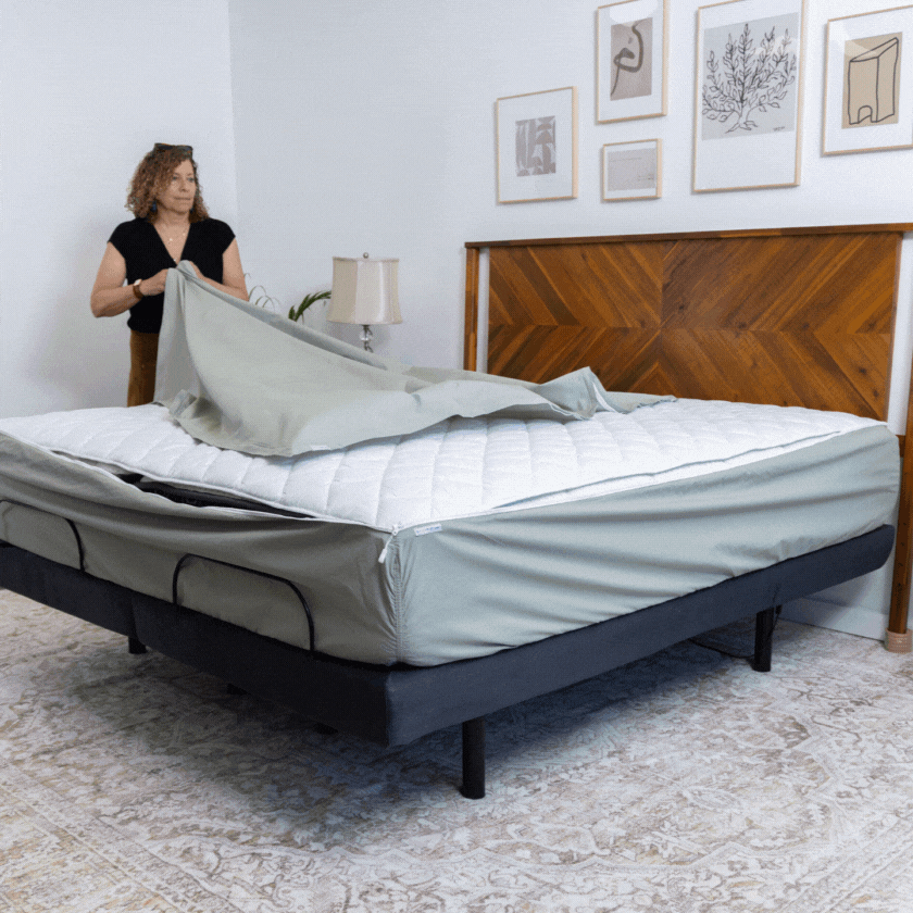 woman zips a fitted sheet onto her mattress