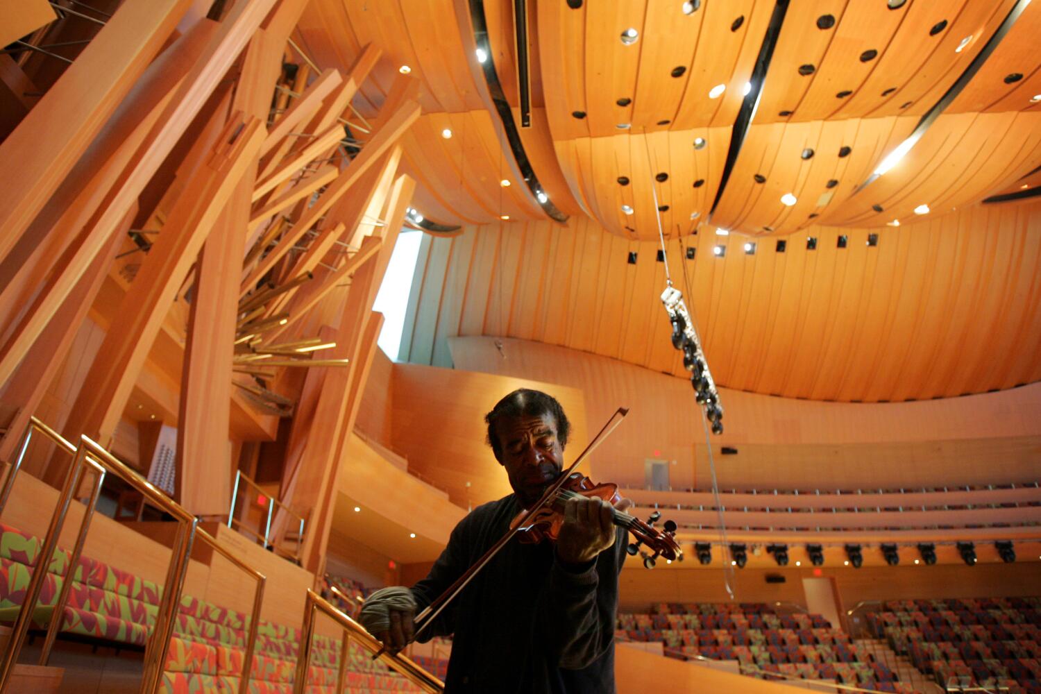 Winter, Damon –– – 103106.ME.1006.lopez –Nathaniel Anthony Ayers, 54, plays his violin in Walt Disney Concert Hall in Downtown Los Angeles Thursday October 6, 2005. Nathaniel attended Juliard, the acclaimed New York City music school on a scholarship as a young man. He is now homeless, living on the streets of Los Angeles' skid row with all his belongings in a shopping cart he calls 