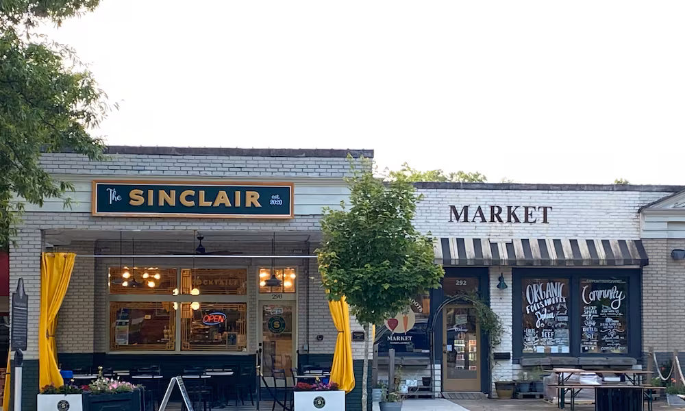 This 2023 photo shows the exteriors of The Sinclair and Community Roots Market, two restaurants impacted by a big fire in Madison. (Ligaya Figueras/AJC)