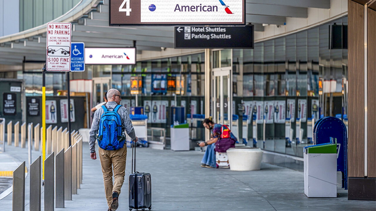 A solo traveller approaches an American Airlines check-in area at the San Francisco International Airport in Oakland, California