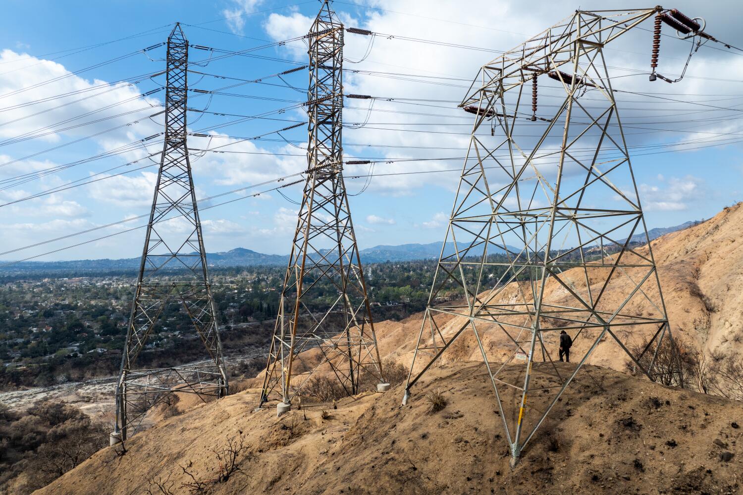 Altadena, CA - February 11: Investigators view the Edison electrical lines, transmission towers and surrounding area, which is a location that is being investigated as the possible origin of the Eaton fire in Eaton Canyon in Altadena Tuesday, Feb. 11, 2025. (Allen J. Schaben / Los Angeles Times)