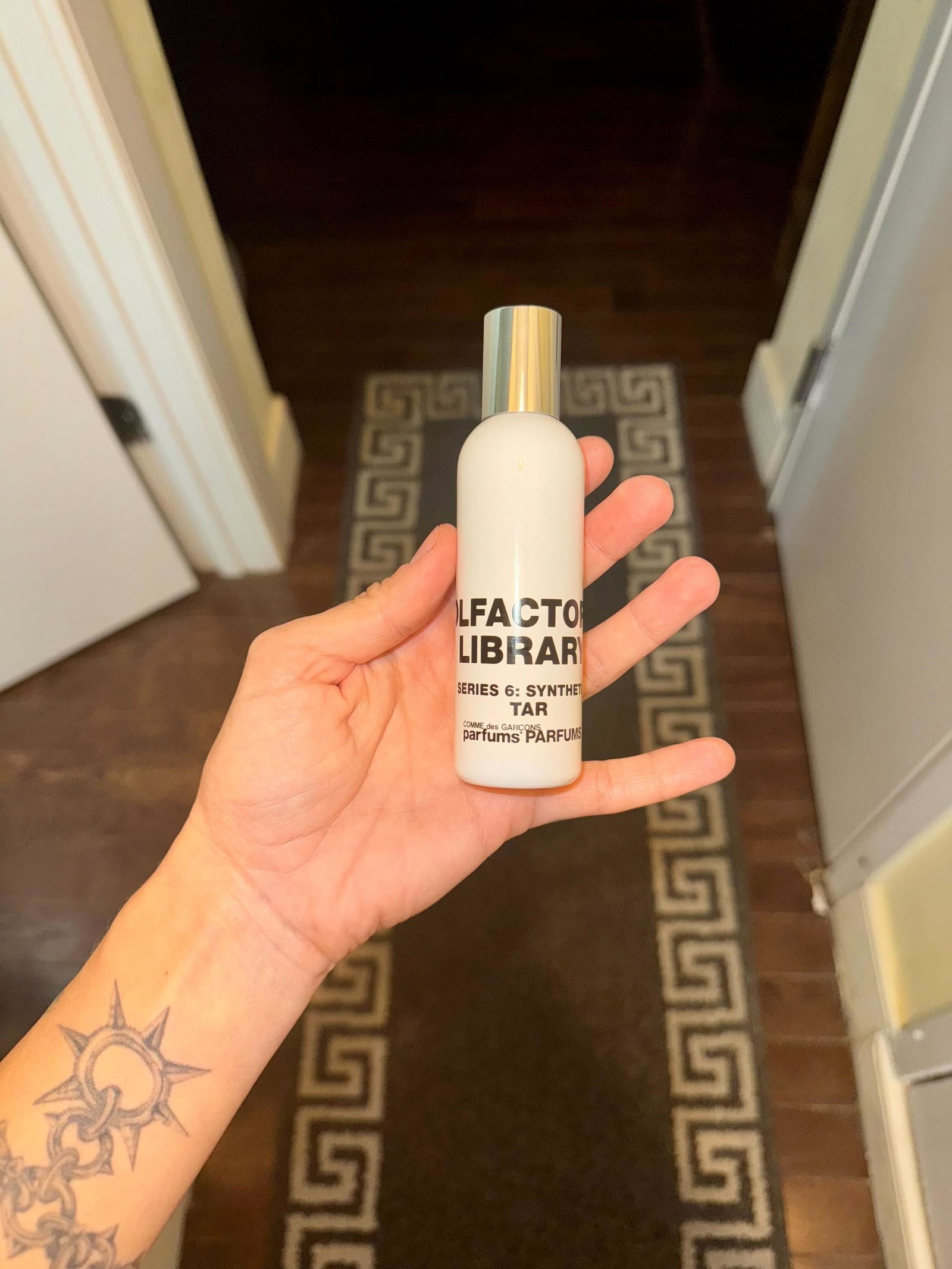 Image may contain: Bottle, Cosmetics, Perfume, Person, and Baby