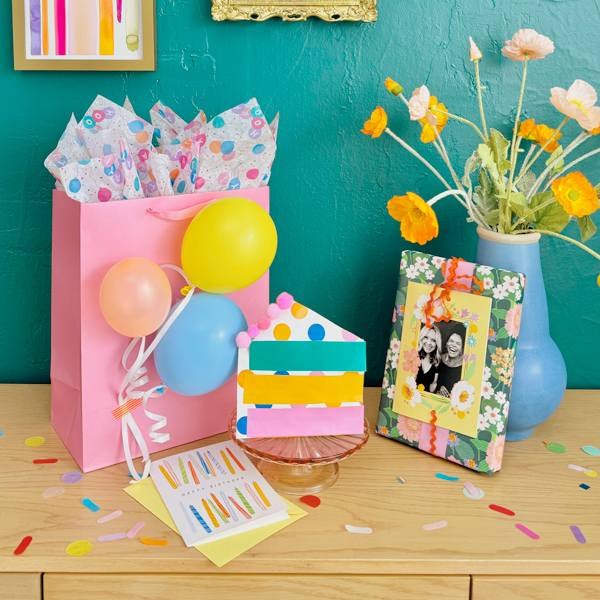 Gift bag with tissue and balloons.