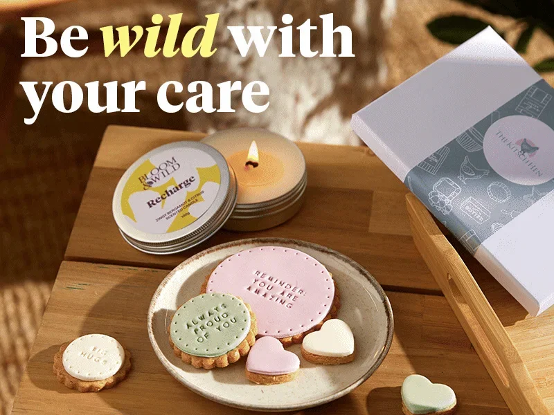 Image switches between a plate of biscuits with hand-iced positive messages next to a burning candle and a close up of flowers in pink and purple hues. Text over the top reads 