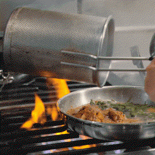 GIF: Cooking food in skillet over fire