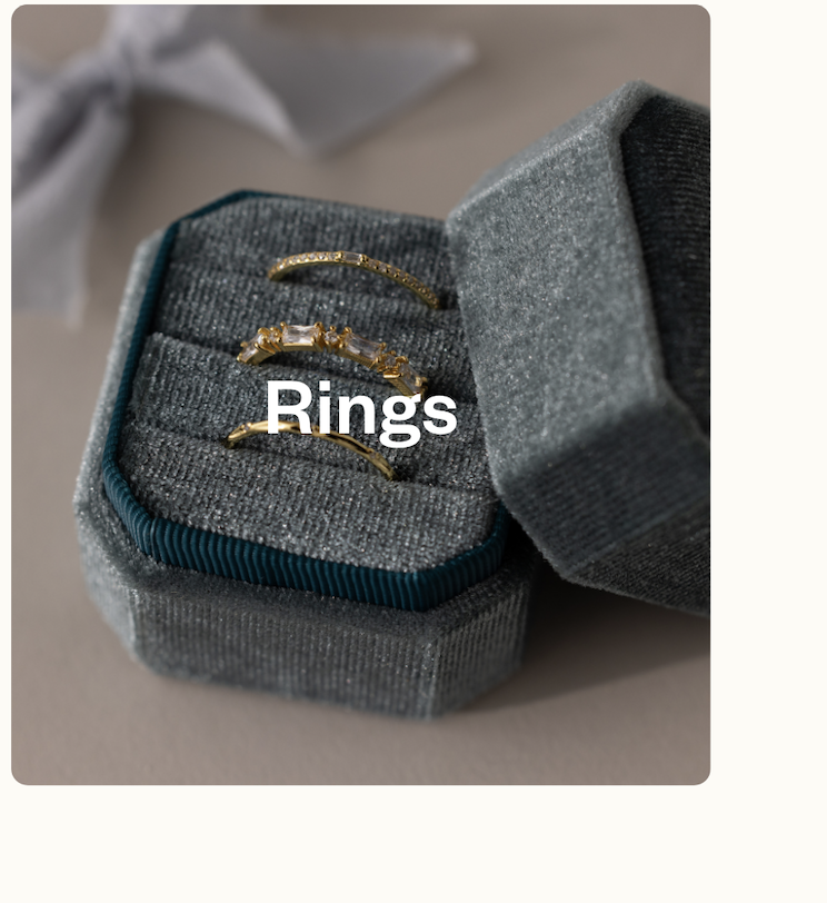 “Stacked Caitlyn Minimalist rings on a textured surface. Text overlay: Rings.”