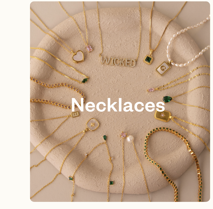 Necklaces: “Close-up of Caitlyn Minimalist gold necklaces displayed on linen fabric. Text overlay: Necklaces.”