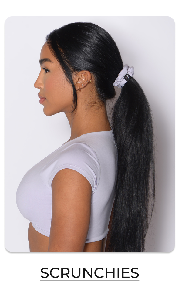 image of model wearing B Scrunchie in Galactic Lilac with text