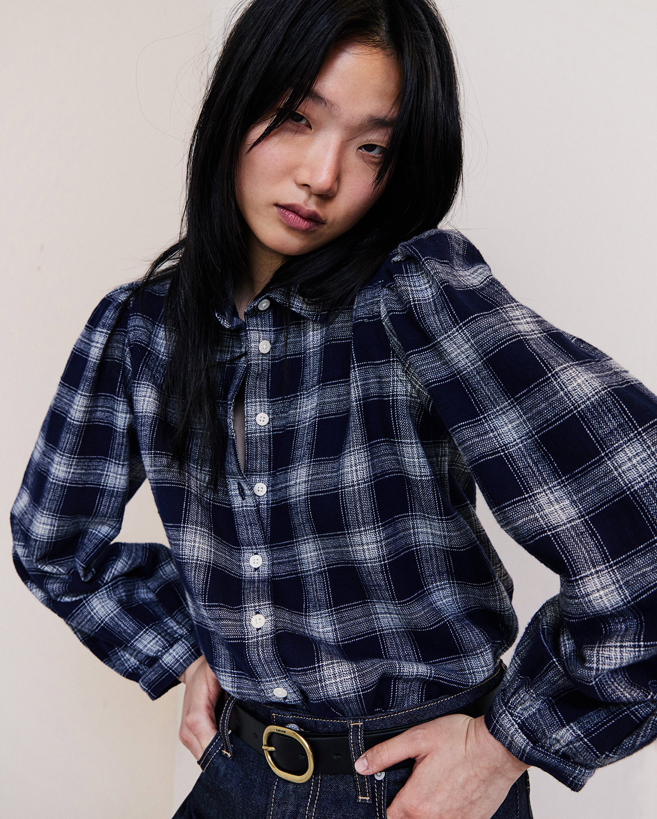 Woman wearing a plaid button up shirt