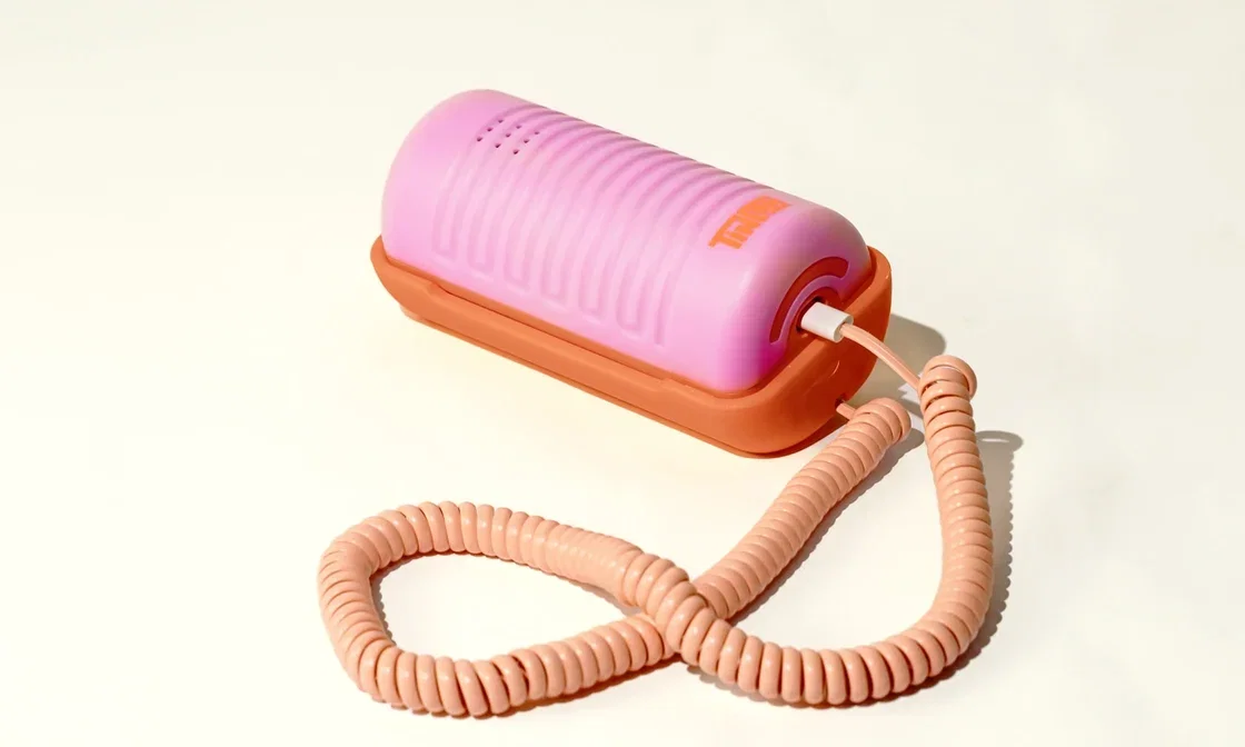A pink and orange landline Tin Can phone.
