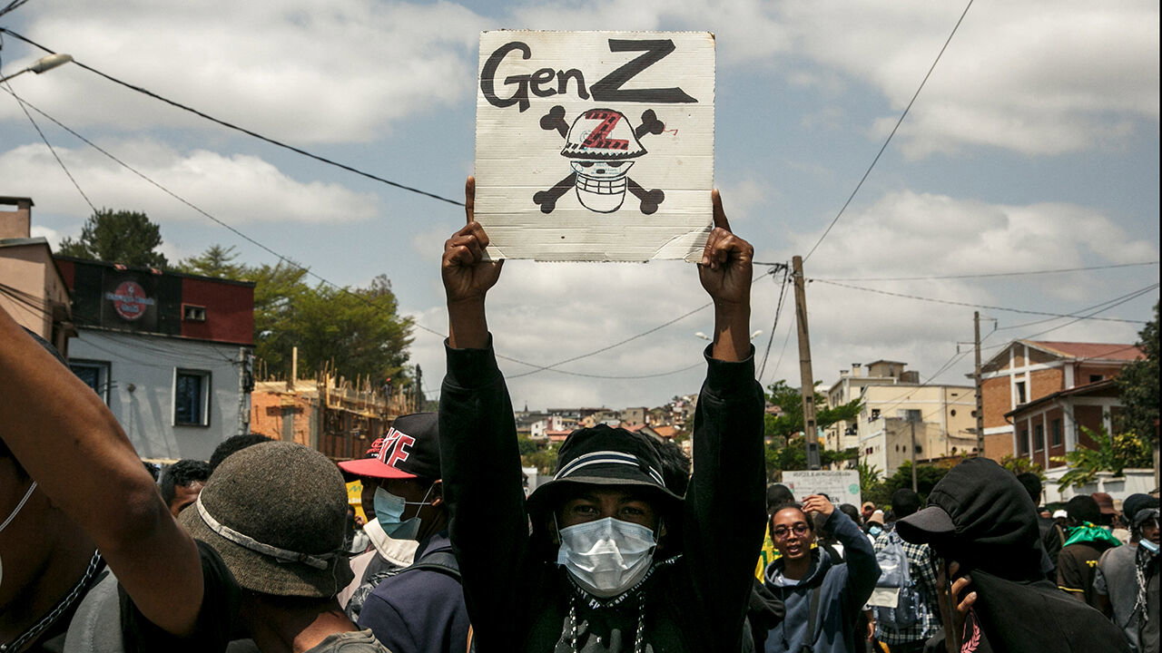 A protester holds a placard during a demonstration against repeated water and electricity outages in Antananarivo, Madagascar