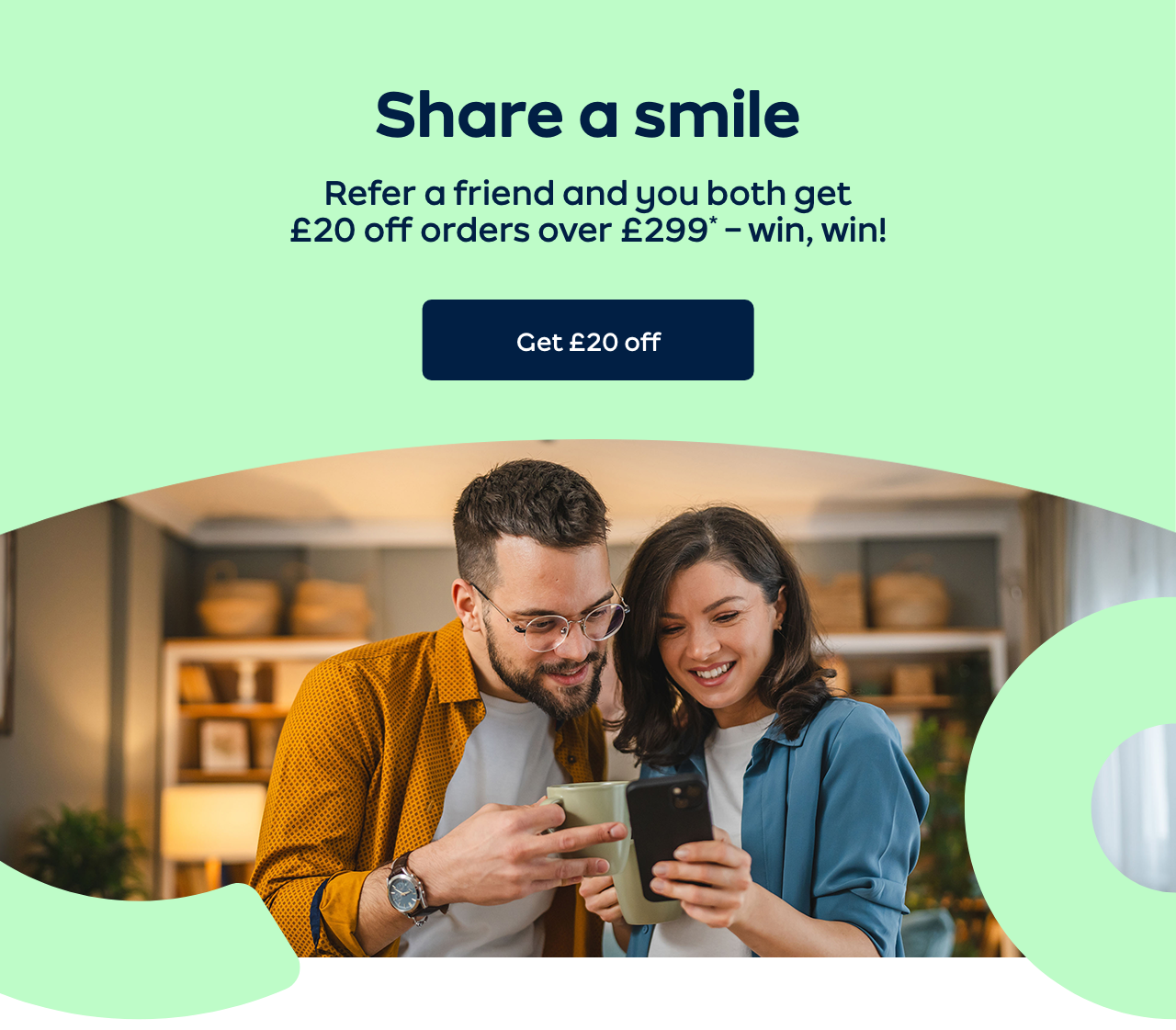 Two friends smiling at a phone 