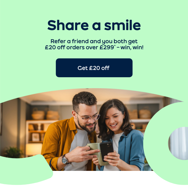 Two friends smiling at a phone 