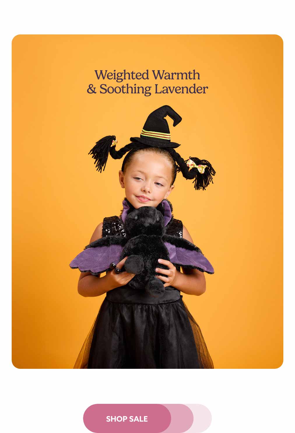 A little girl holding Purple Wing Bat Warmies while wearing a witch costume against an orange background. Shop Sale.
