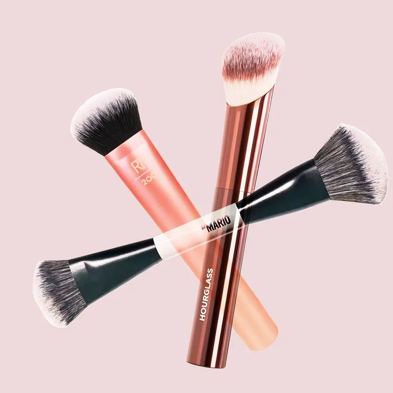 A collage of Hourglass, Real Techniques, and Makeup by Mario foundation brushes on a light pink background