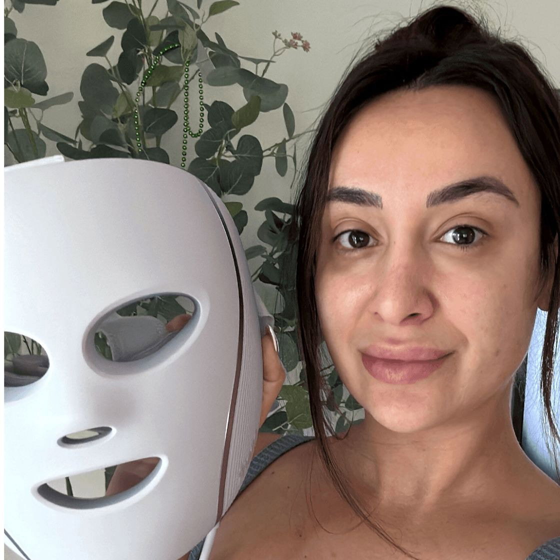Image contains Allure editors holding LED masks for acne