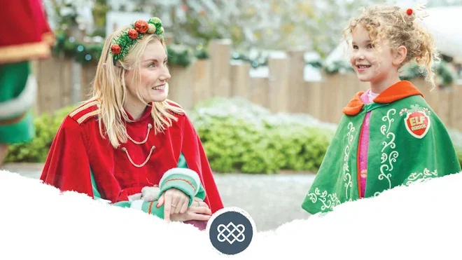 elf spending time with girl in elf school cape