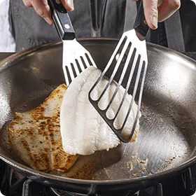 Browning a white fish fillet in a skillet