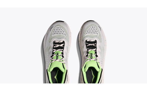 A side view image of the HOKA Kawana 2 gym shoe in White / Tart Apple.