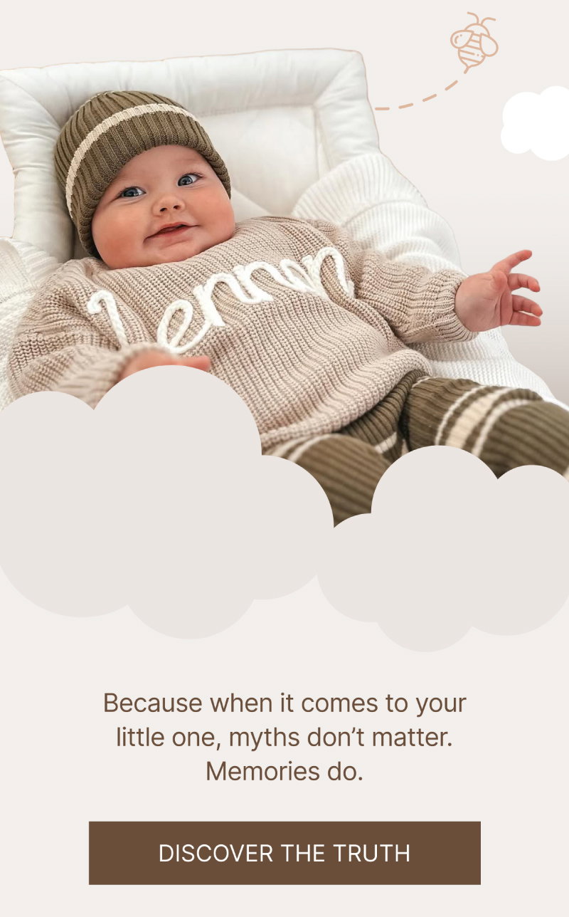 Smiling baby wearing a beige knitted jumper with “Henry” stitched across the front, matching beanie and striped pants, positioned above a brown “Discover the Truth” button.