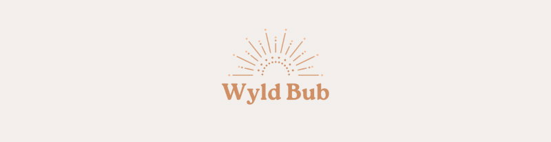 Logo with stylized sunburst design above the words “Wyld Bub” in a soft tan color on a light background.