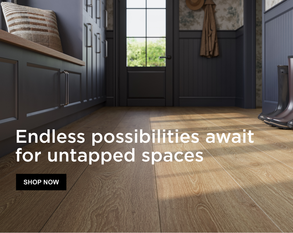 Caption: Endless possibilities await for untapped spaces, SHOP NOW. Close-up of  entryway with medium blonde wood-look performance flooring.