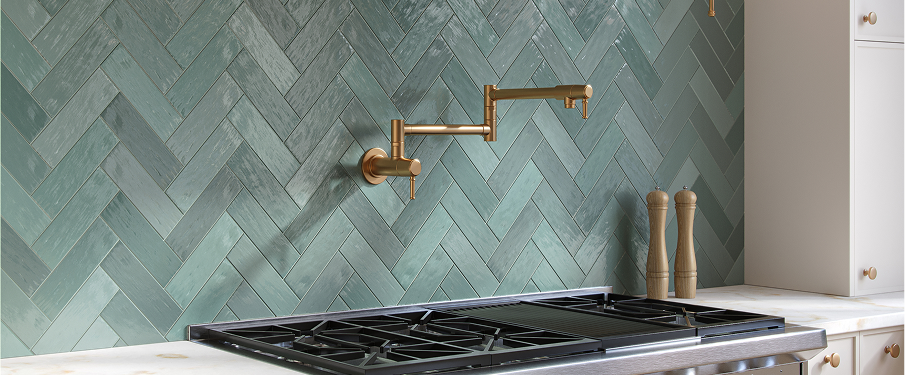 Green-teal herringbone pattern backsplash in kitchen.