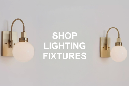 Caption: SHOP LIGHTING FIXTURES. Close-up of brushed gold ball sconces.