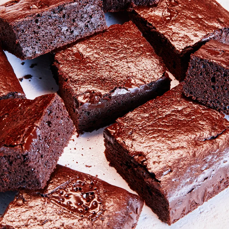 a close up of brownies on a white plate