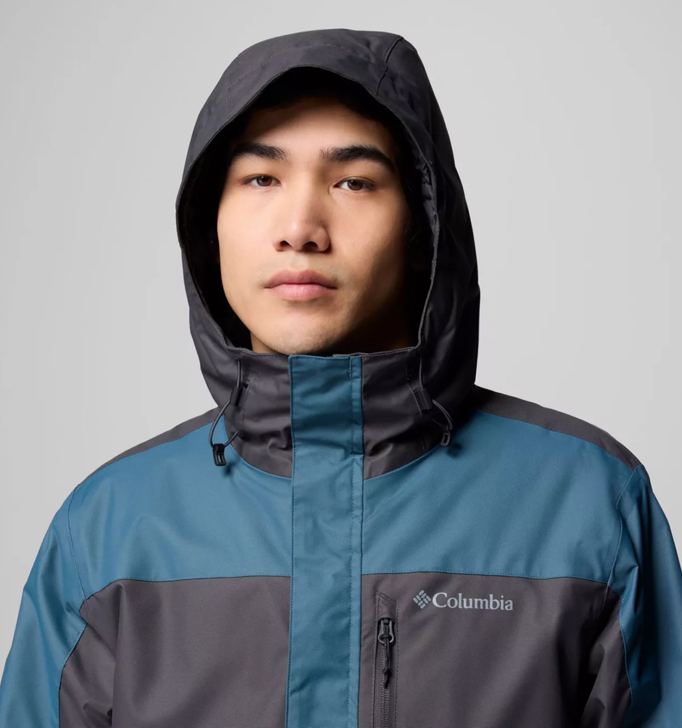 A man wearing a black and blue jacket.