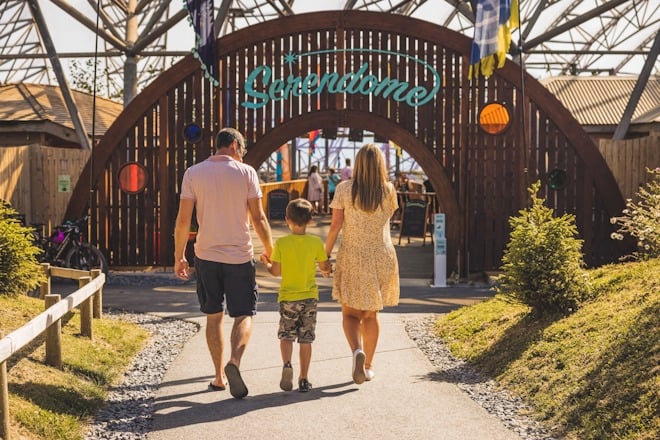 family walking into serendome at summer
