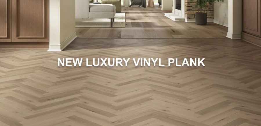 Caption: Luxury Vinyl Plank. Luxury vinyl plank flooring in a modern home interior, featuring a herringbone pattern in the foreground and straight planks in the background, with neutral-toned walls and furniture.