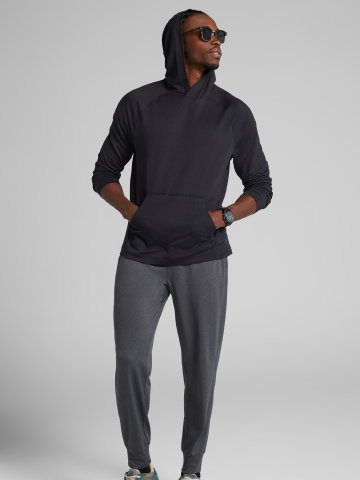Man in black hoodie and gray joggers.