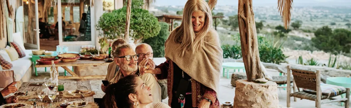 Friends gather to share a meal on the beautiful patio of a vacation home.