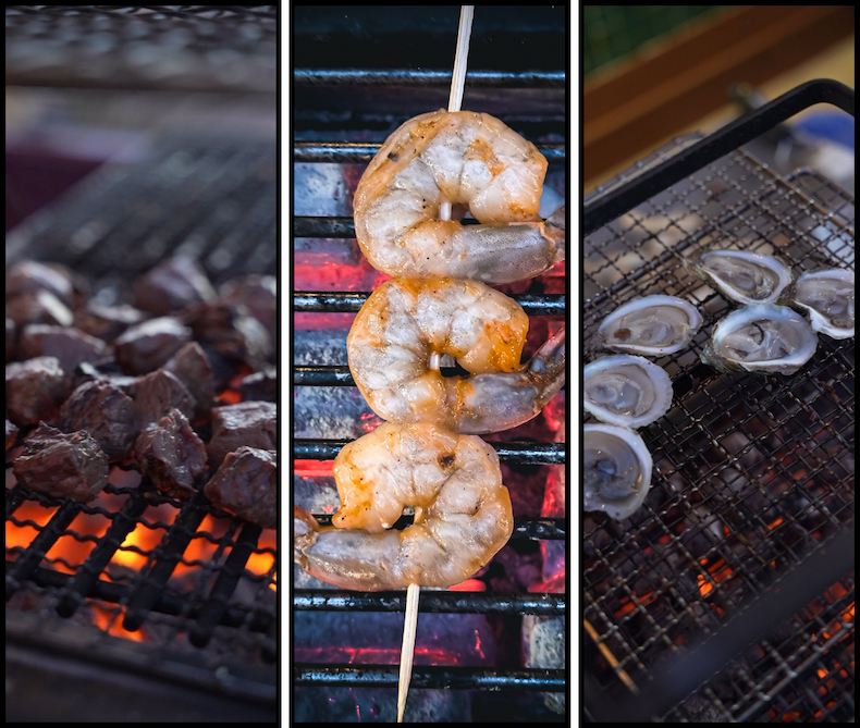 steak bites, shrimp skewer and oysters on a grill